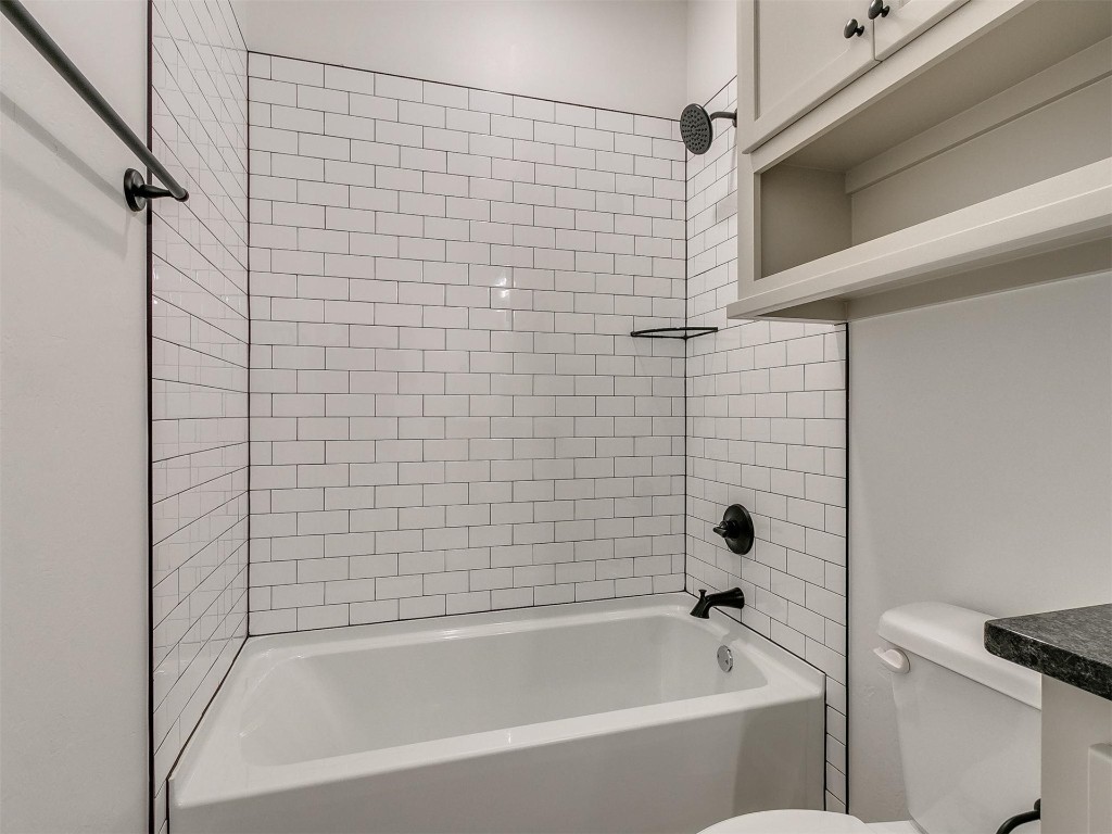 1226 Deer Ridge Boulevard, Tuttle, OK 73089 bathroom with tiled shower / bath and toilet