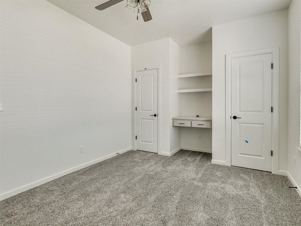 1226 Deer Ridge Boulevard, Tuttle, OK 73089 unfurnished bedroom with ceiling fan and light colored carpet