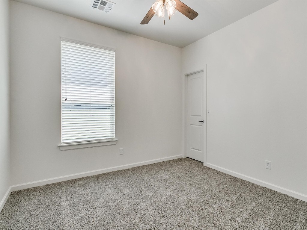 1226 Deer Ridge Boulevard, Tuttle, OK 73089 carpeted empty room featuring a healthy amount of sunlight and ceiling fan