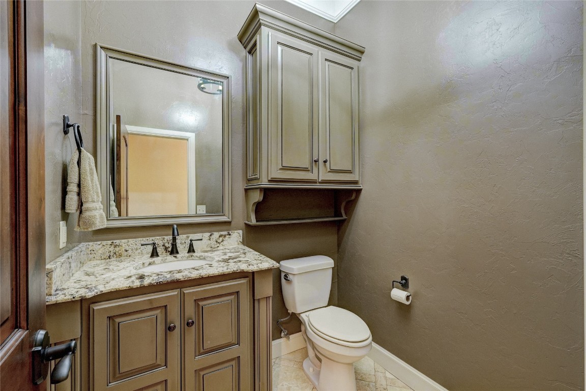 2355 La Belle Rue, Edmond, OK 73034 bathroom featuring vanity, toilet, ornamental molding, and tile floors
