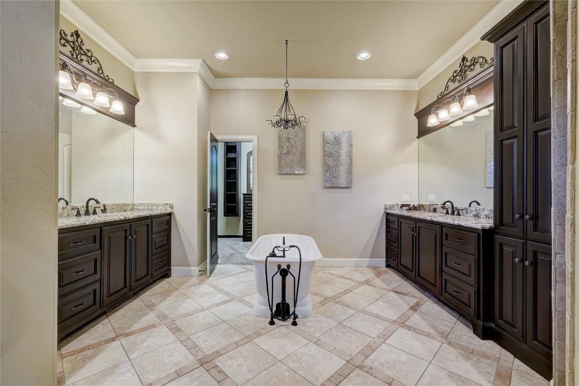 2355 La Belle Rue, Edmond, OK 73034 bathroom with vanity, crown molding, an inviting chandelier, and tile flooring