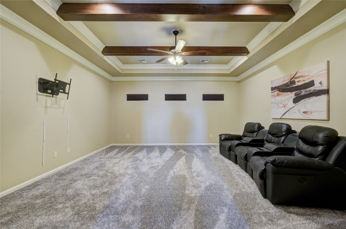 2355 La Belle Rue, Edmond, OK 73034 sitting room with beam ceiling, ceiling fan, ornamental molding, and carpet flooring