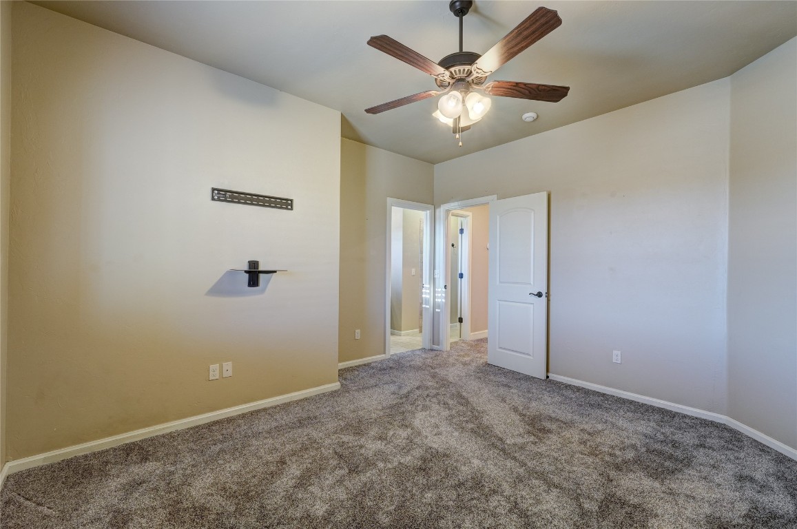 2355 La Belle Rue, Edmond, OK 73034 unfurnished bedroom with ceiling fan and carpet
