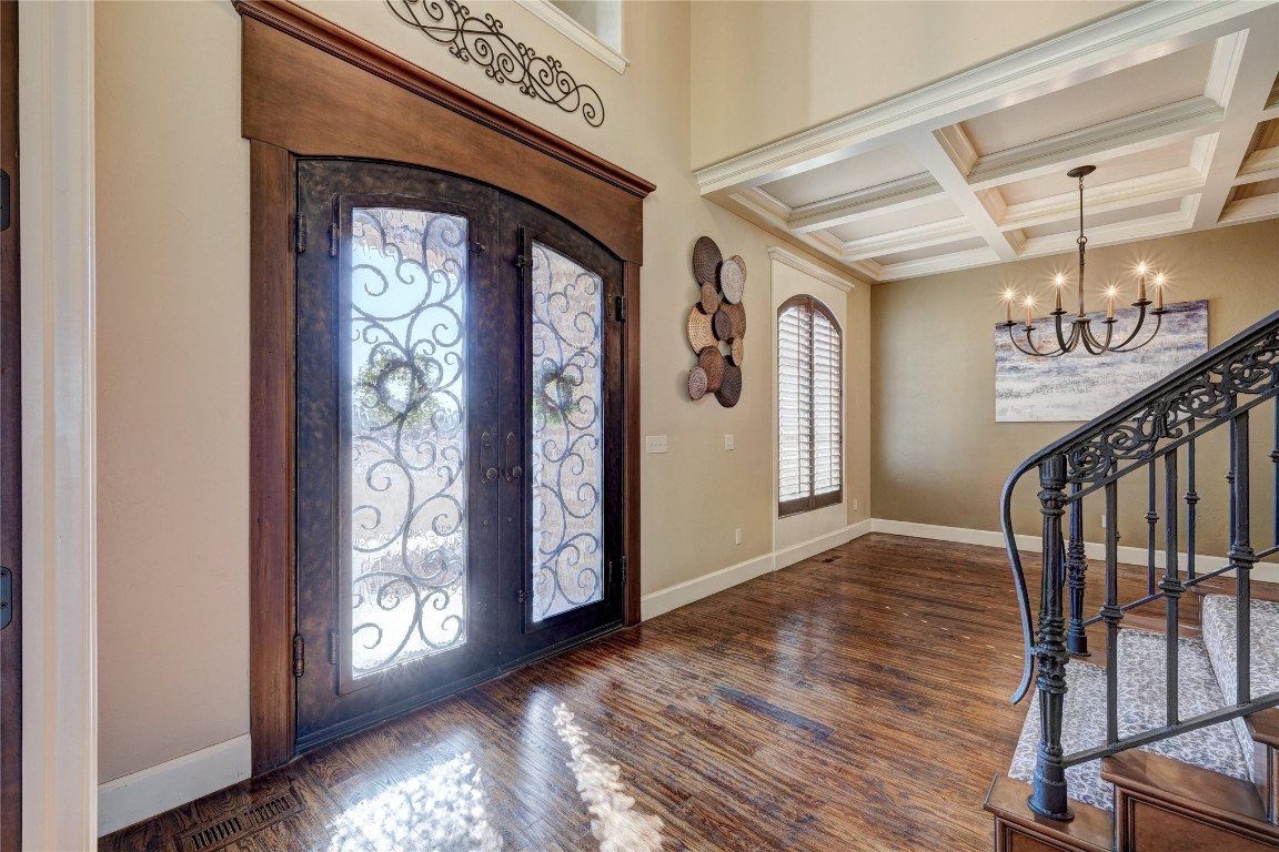 2355 La Belle Rue, Edmond, OK 73034 entryway with dark hardwood / wood-style flooring, a notable chandelier, french doors, coffered ceiling, and beamed ceiling