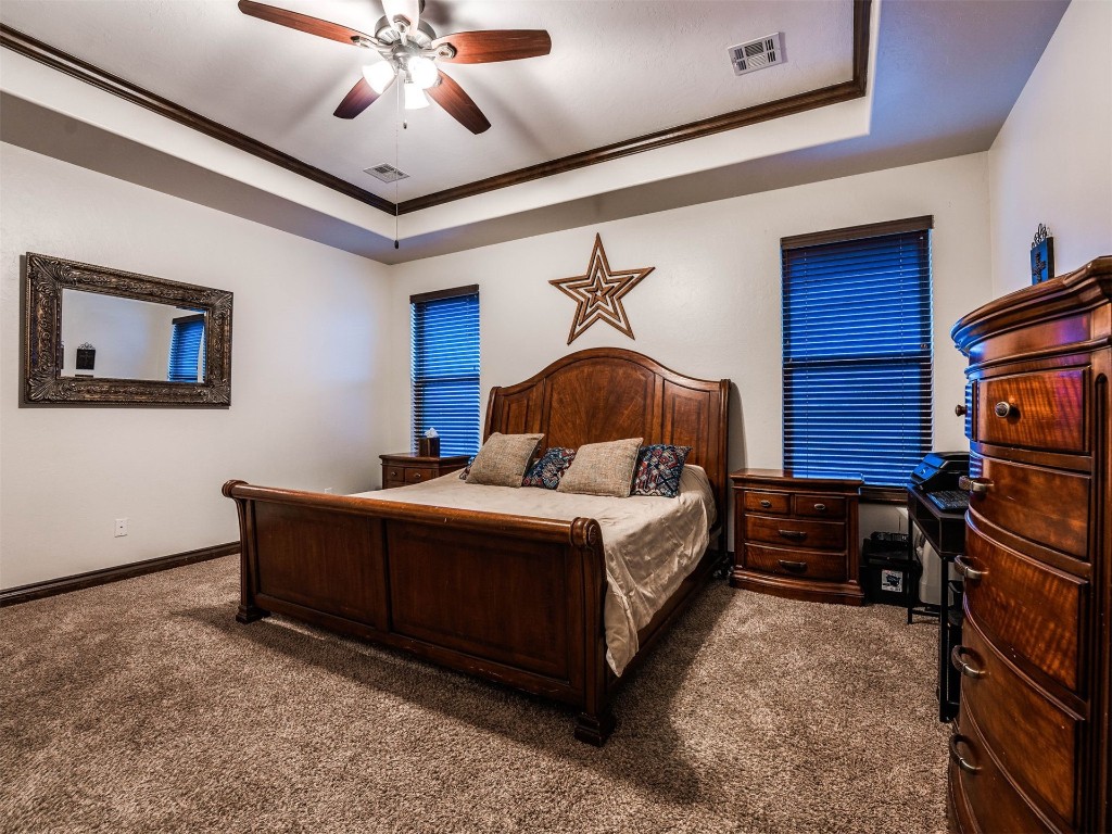 112 Old Home Place, Yukon, OK 73099 carpeted bedroom with ceiling fan and a tray ceiling