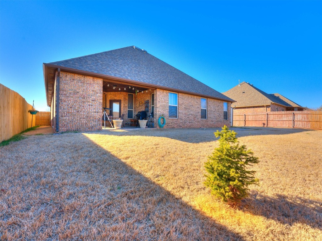 112 Old Home Place, Yukon, OK 73099 back of property with a patio area and a yard
