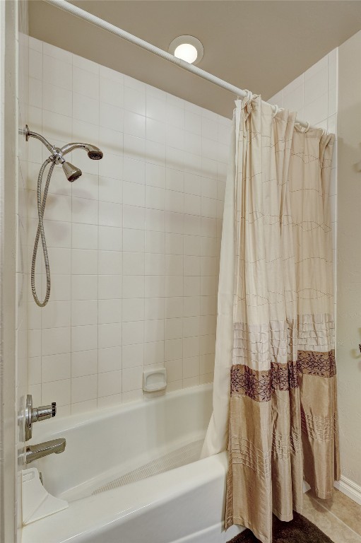 1941 Oak Creek Terrace, Edmond, OK 73034 bathroom featuring shower / bathtub combination with curtain