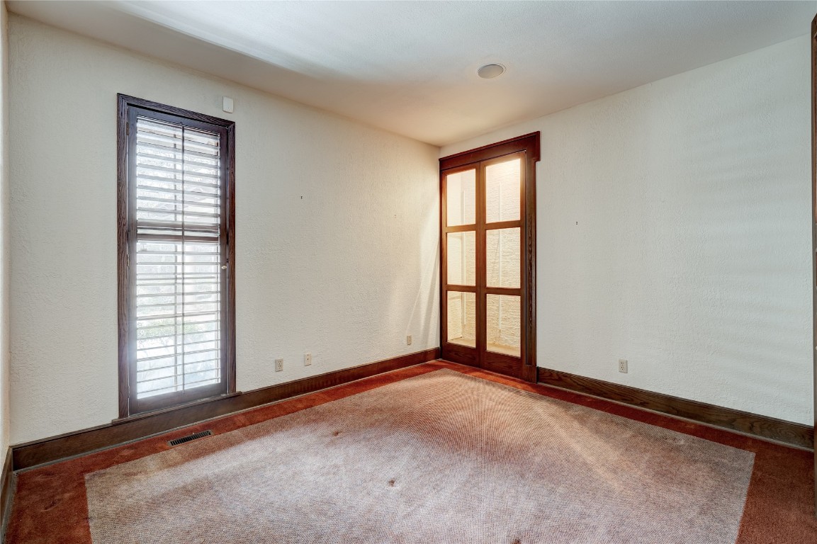 3900 S Bryant Avenue, Edmond, OK 73013 carpeted empty room featuring a wealth of natural light