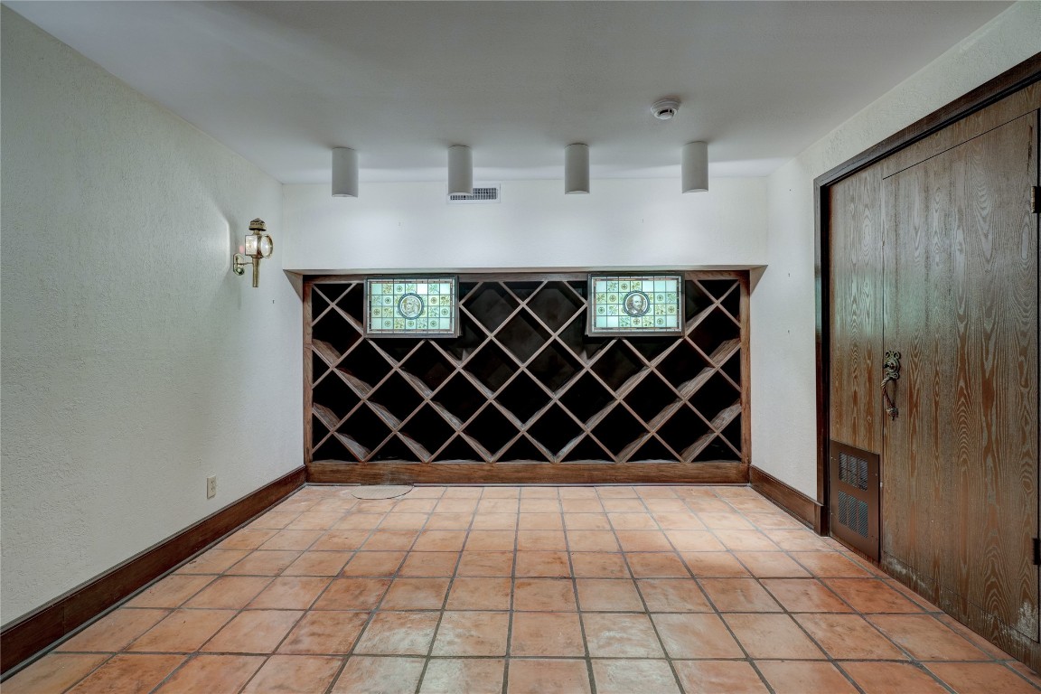 3900 S Bryant Avenue, Edmond, OK 73013 wine room with light tile flooring