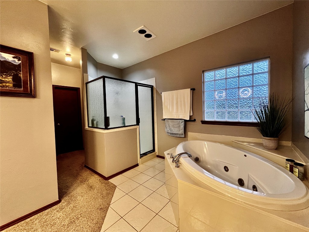 5808 E McMillin Dr, Tuttle, OK 73089 bathroom with tile floors and shower with separate bathtub