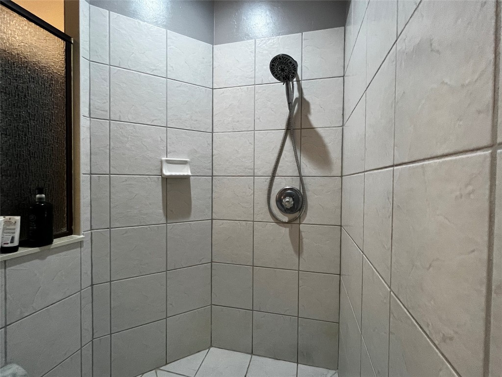 5808 E McMillin Dr, Tuttle, OK 73089 bathroom featuring an enclosed shower