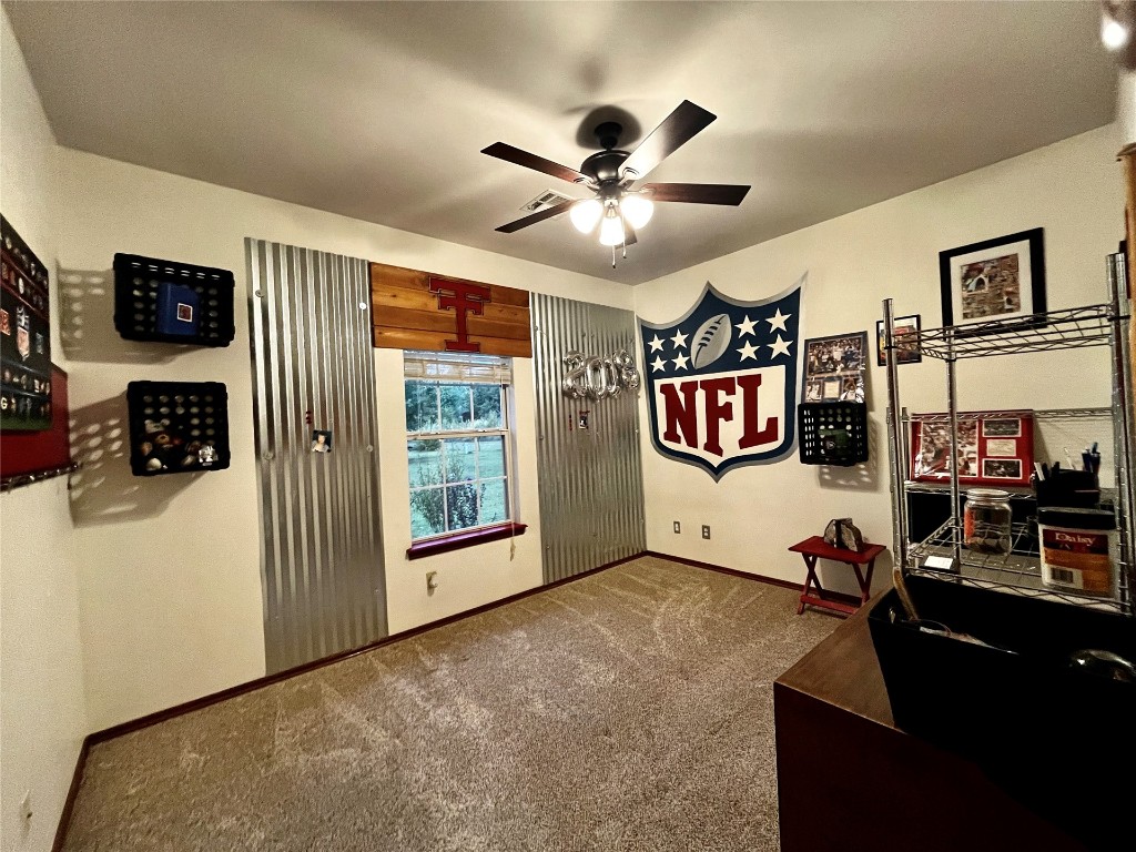 5808 E McMillin Dr, Tuttle, OK 73089 home office featuring dark colored carpet and ceiling fan