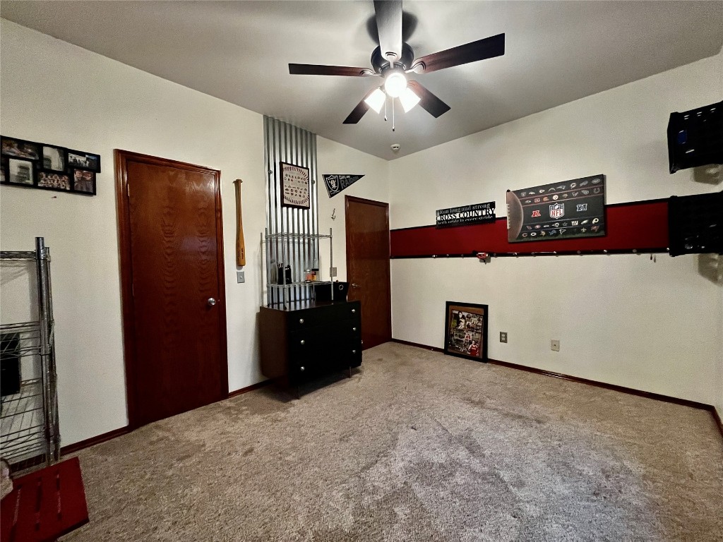 5808 E McMillin Dr, Tuttle, OK 73089 unfurnished bedroom featuring ceiling fan and light colored carpet