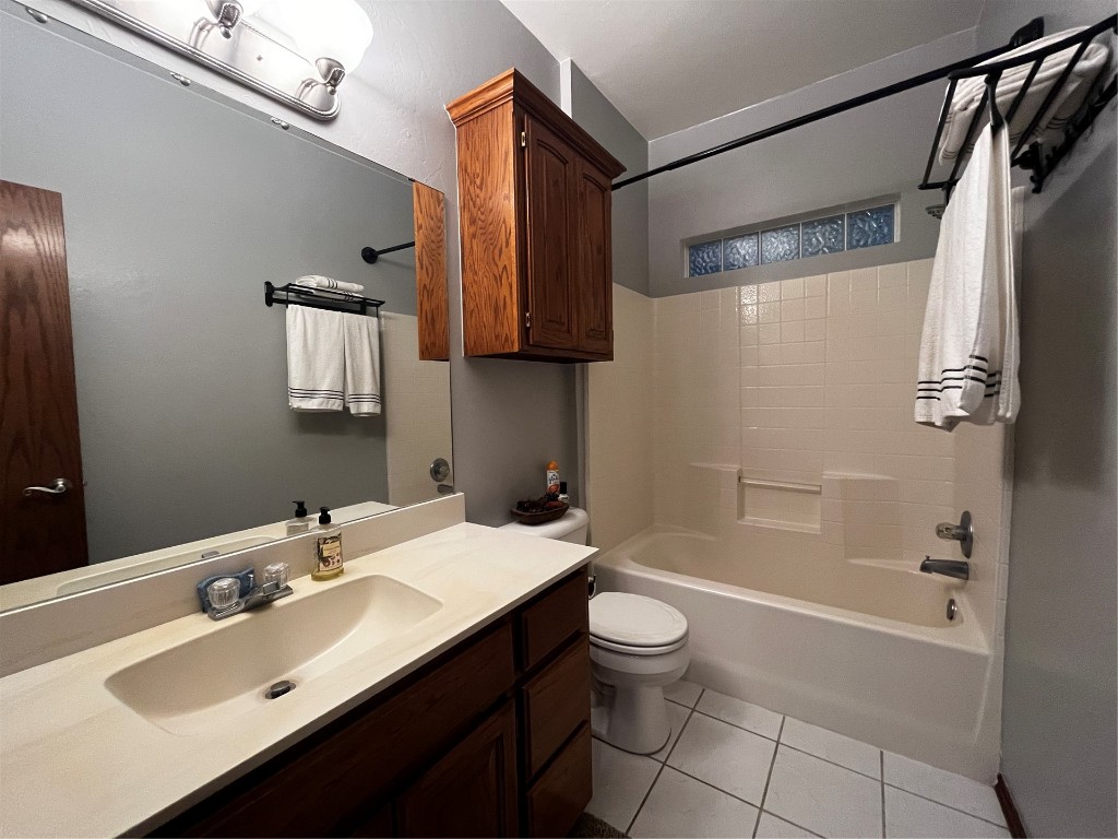 5808 E McMillin Dr, Tuttle, OK 73089 full bathroom featuring vanity, toilet, shower / bathtub combination, and tile floors