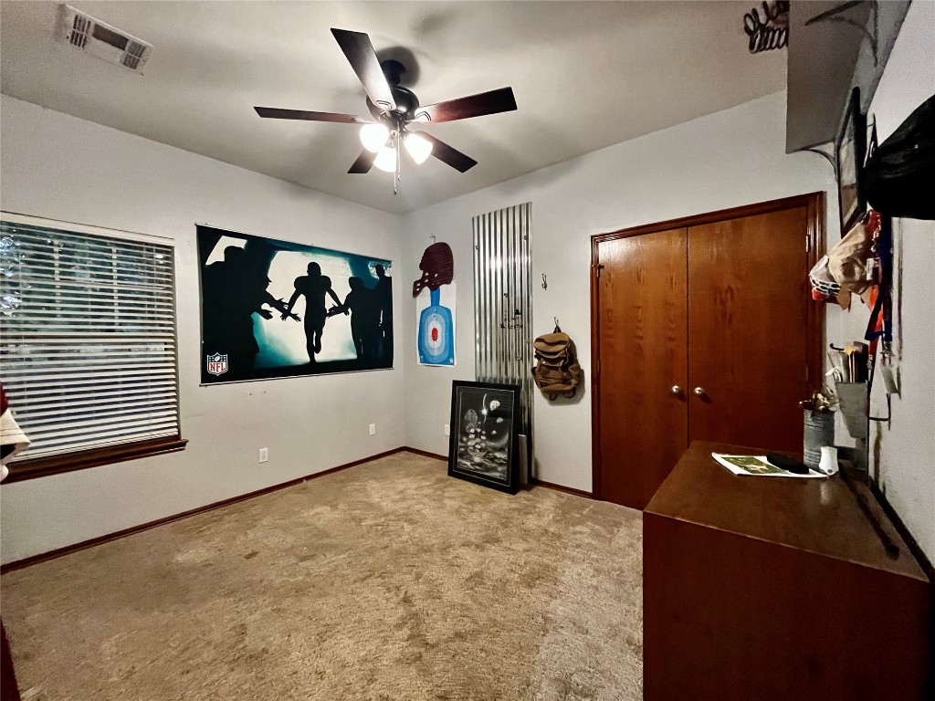 5808 E McMillin Dr, Tuttle, OK 73089 interior space with light carpet and ceiling fan