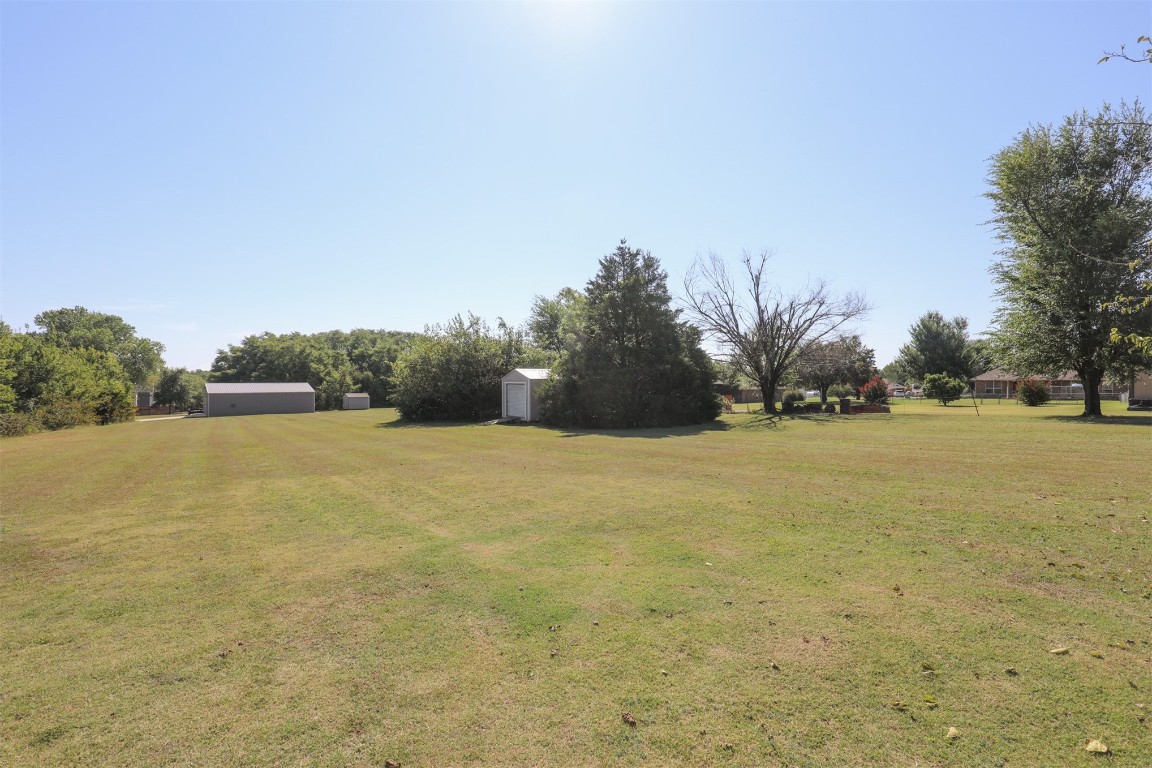 5808 E McMillin Dr, Tuttle, OK 73089 view of yard featuring an outdoor structure
