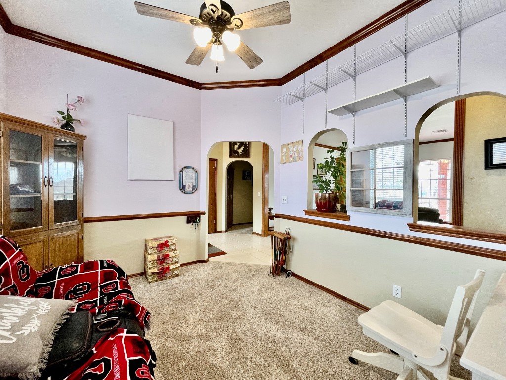 5808 E McMillin Dr, Tuttle, OK 73089 interior space featuring crown molding, ceiling fan, and light colored carpet