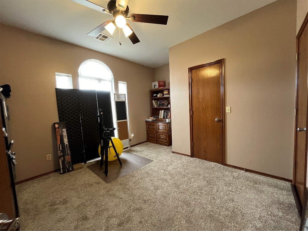 5808 E McMillin Dr, Tuttle, OK 73089 interior space with ceiling fan and light colored carpet