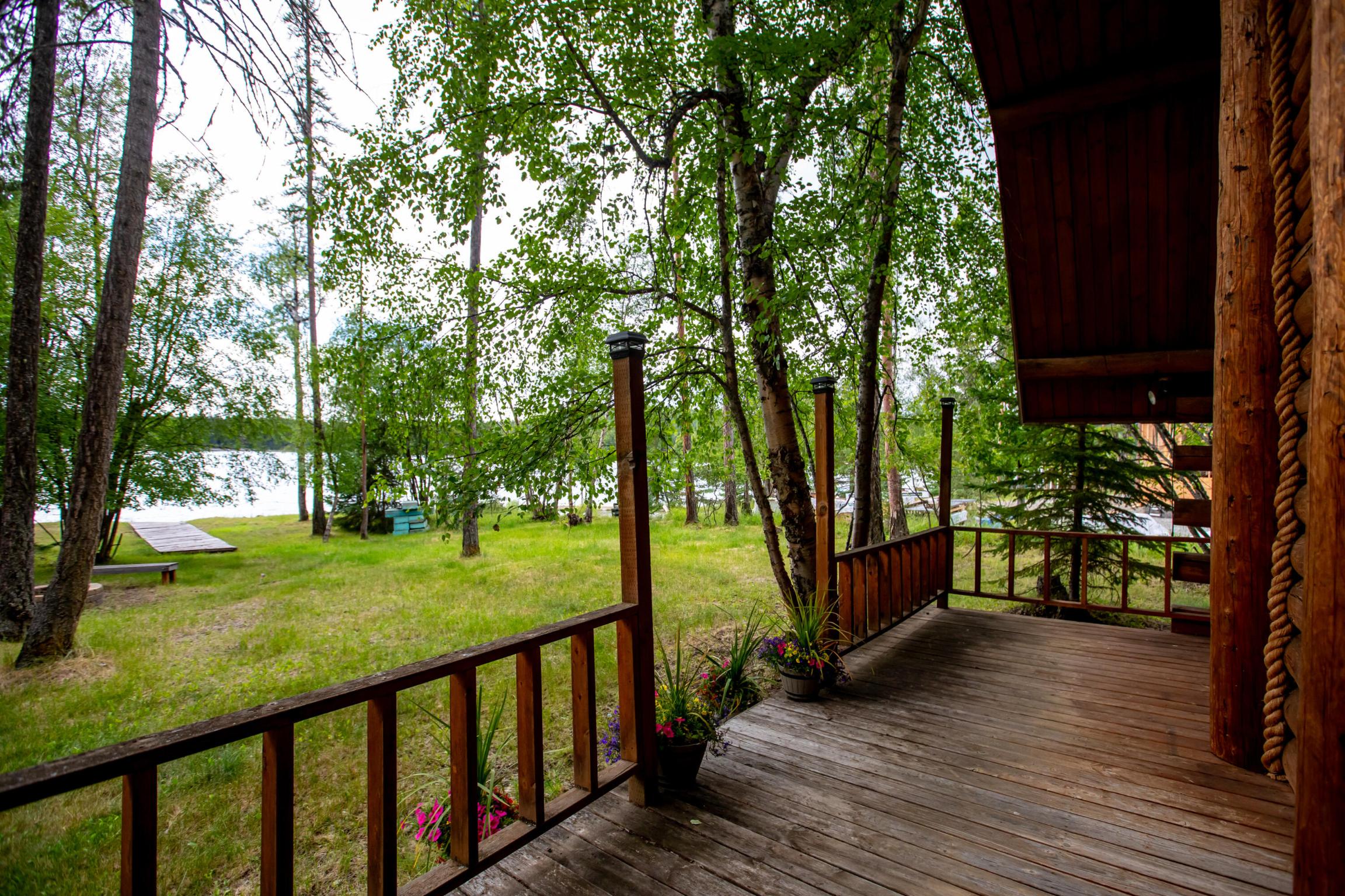 The ultimate ''Montana Cabin in the Woods'' features 100 ft of water front on the pristine mountain lake, Glen Lake, just 45 miles north of Whitefish. Enjoy the Amish built log cabin, which was expanded to provide 3 bd/1ba plus oversized garage for storage of toys. Current layout sleeps 12. The .82ac level lot hosts mature pine trees, providing privacy while protecting the home from view from lake or road. The public boat launch is approximately 200 yds north, making this site extremely attractive to the water enthusiast, whether for sport or quiet fishing. Add'l features include large front porch for evening sunsets, a fire pit with benches and dock/walkway to beach. Property is being sold ''AS IS''. Easy to show! Call/text Barb Riley at 406-253-7729 or your real estate professional. Surface Water: Glen Lake