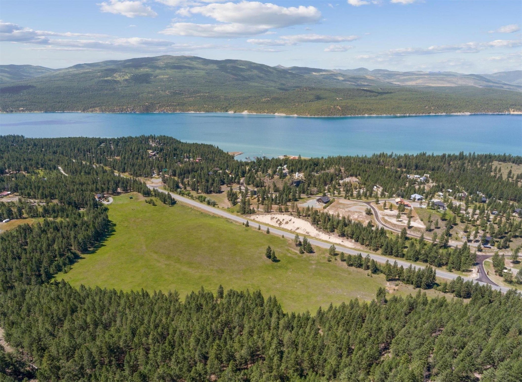 This one-of-a-kind property paints the perfect picture for Montana living. 12.69 acres of prime land, sitting only two minutes from a public ramp on Lake Koocanusa, ready for you!This property has amazing views of Lake Koocanusa and the surrounding area. It is located only 10 minutes from the Canadian Border, a little over an hour from Glacier National Park and Glacier International Airport, and less than a morning's drive to 3 snow/ski resorts. Property is pre-plat status. Tobacco Valley is at one of the lowest elevations in Montana, and this property really shows the beauty of that. With the opportunity to own a couple of horses, and much more this property is a dream. Call Terry Comstock at (406) 250-7722,  or your Real Estate Professional today.