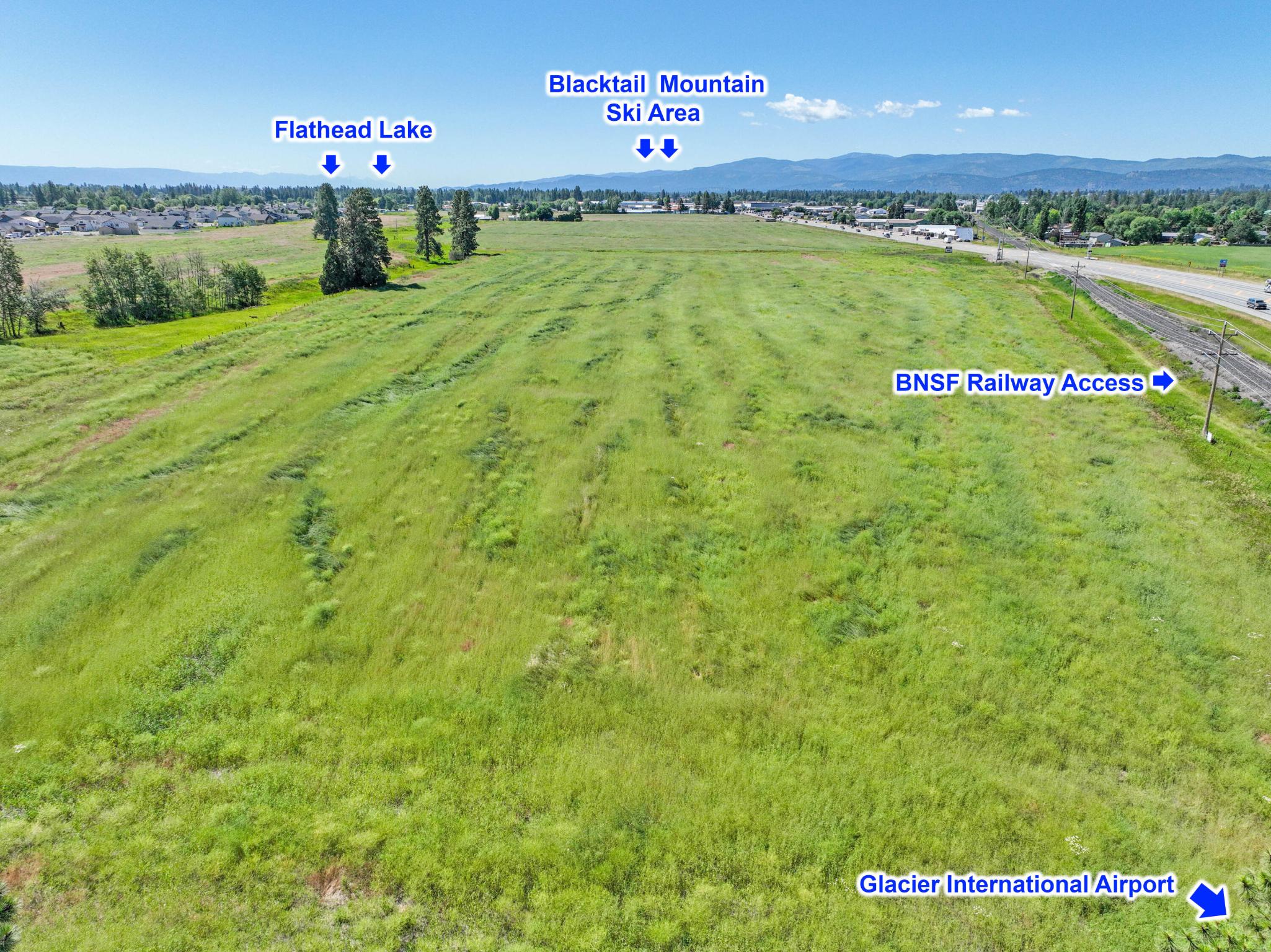 Located in the middle of Flathead Valley, this rare 52+ acres on Highway 2 East has high visibility with average daily traffic count over 17,000. Currently used as agricultural land with established water rights, development possibilities are numerous. This property offers a myriad of business opportunities due to current zoning including hospitality, retail and light industrial to name a few. Option to install a switch yard cooperatively with BNSF Railway approval, for easy transportation of materials or products. It is also located minutes away from local landmarks: Glacier International Airport, Glacier National Park, Flathead Lake, Whitefish Mountain Resort and so much more. Call Mark Kuhl (406) 407-7509 or your Real Estate Professional