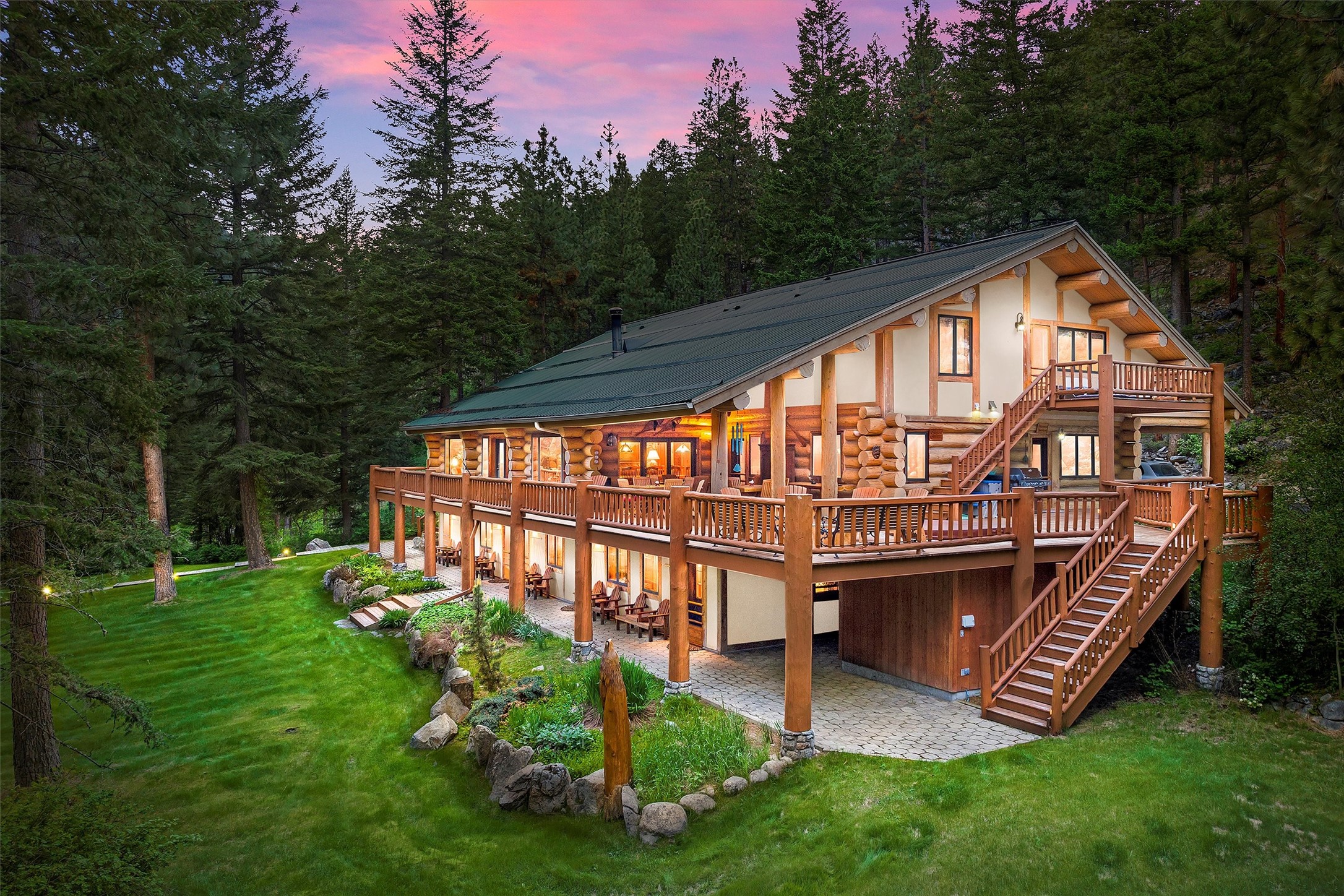 Situated at the mouth of Bear Creek Canyon is this secluded and magical destination known as Bear Creek Lodge.  Totaling 154.45 acres w/ year-round creek and shouldered by USFS on 2 sides, this unique property is truly a gem in our treasured state.  The classic 8,900 +- sf lodge is built with enormous logs from the Yellowstone NP vicinity.  A generous deck w/hot tub & covered area adds to the outdoor living space. Operating for 20 years as a desirable get-away for guests from around the world, the Lodge consists of 8 well-adorned guest rooms that capture the essence of nature.  Each ‘themed’ room features a private bathroom + outdoor exit. Melt your worries away by a crackling fire in the Great Room, retreat to the library, media/conference room or exercise room w/sauna. A 3-stall barn & 4-acre meadow are ideal for horses. Hike/ride into Forest Service and adjacent wilderness lands.  Go birding, fishing, or wildlife watching. Rejuvenate! Let your imagination soar at Bear Creek Lodge! Pick up where the owner left off to create a new retreat as a respite for visitors, or envision the possibilities for your own personal use.  All personal property is included.  Less than 1 hour driving time to the Missoula International airport!