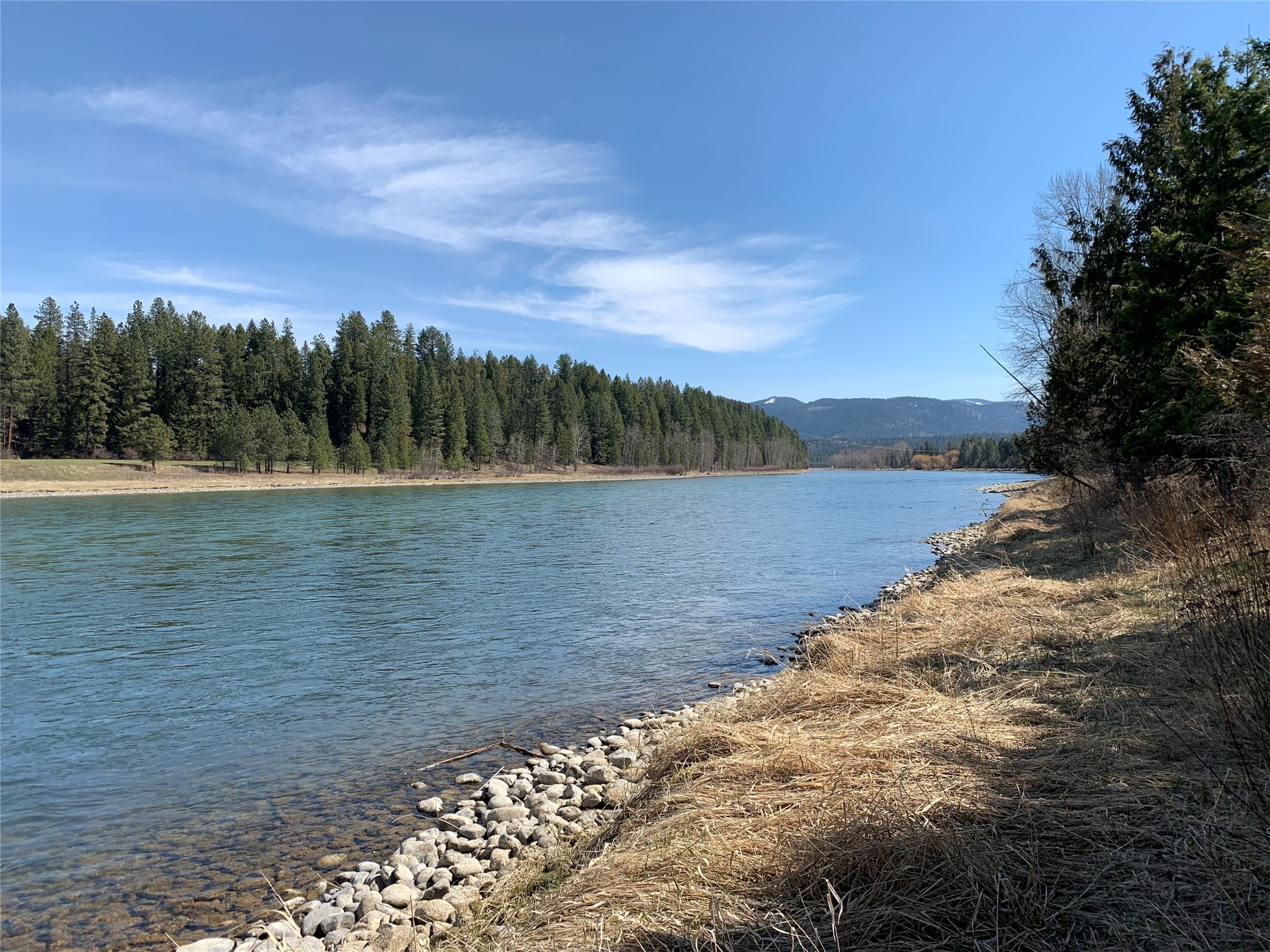 345 feet of Kootenai River frontage!  This 9.57 acres is level with some trees and has a 60 gpm well, power telephone and and septic approval. With Cabinet Mountain views it is located just one mile from Libby.  Must see to appreciate! Listing agent is related to an employee of Seller. Call Chris Faulkner at 406-291-3269 or your real estate professional.