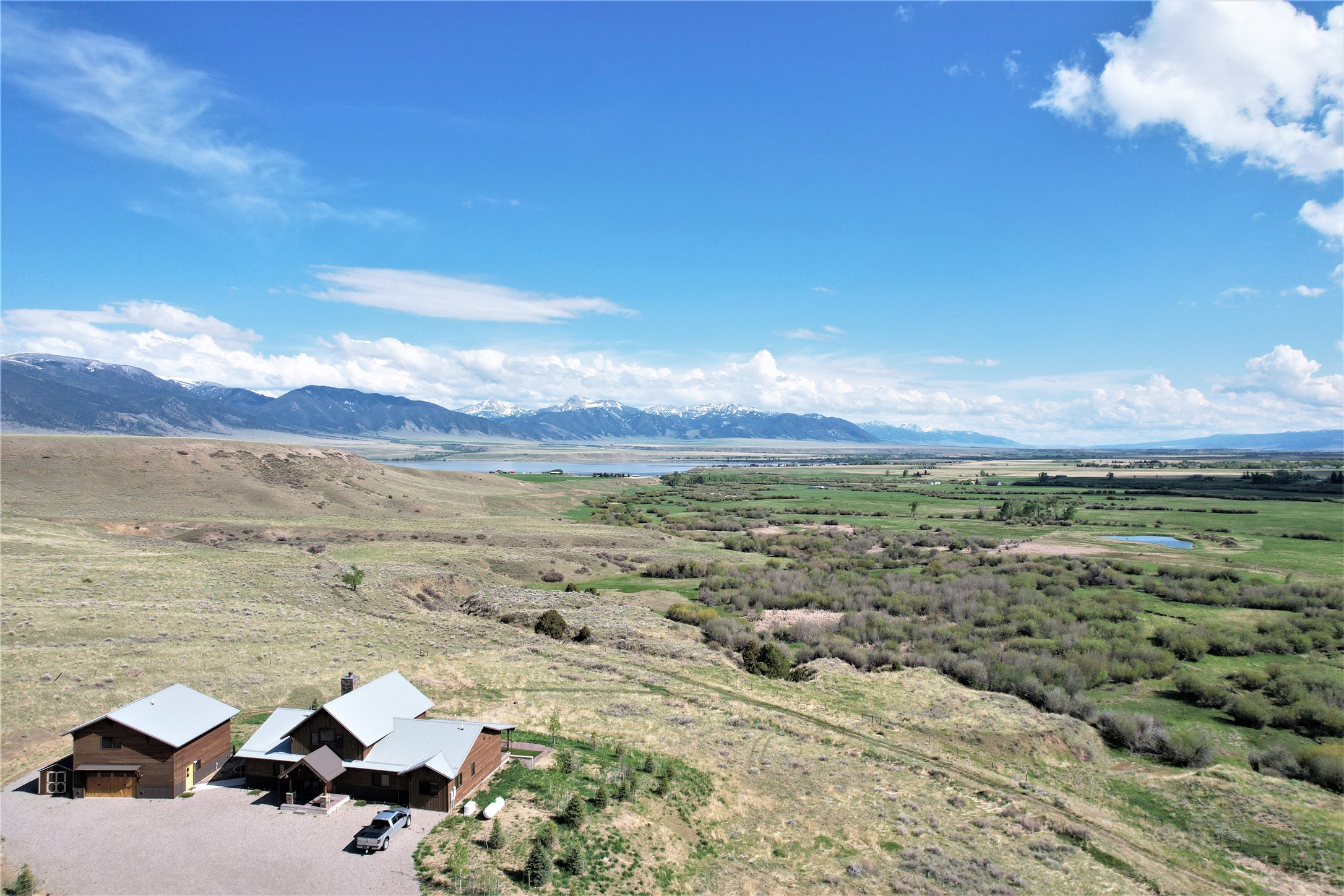 Black Barrel Ranch is located less than an hour to Bozeman and features 5 bedrooms and 3.5 baths in this beautiful custom home plus there is a detached guest apartment over a 3 car garage. All of this is situated on 150+/- acres (2 parcels allowing a new Buyer even more flexibility) looking south down the famed Madison Valley to the Yellowstone National Park caldera on a clear day. Ringed by three mountain ranges (The Madisons, the Tobacco Roots, and the Gravellys) this home can be the center of your recreational lifestyle. Bring your binoculars to watch the wildlife (moose, deer, antelope, blue heron & more) as they drink from your private pond just south of the house. This property is NOT encumbered by covenants, zoning, nor conservation easement giving you the perfect opportunity to bring your horses, cattle, chickens and any other animals to create your very own small ranch. The guest apartment could also be a perfect place for a caretaker. Enjoy your evenings watching Alpen glow cover the mountains from large deck or cozy up in front of the wood burning stack rock fireplace as you soak in the quiet and solitude that living in the mountains can bring. Hiking, hunting, fishing are all out your door or take a quick drive for winter snow-skiing (3 major hills within 2 hours) or bring your boat and hit Ennis Lake. In Montana you don't just buy a property......you purchase a new lifestyle. If you are looking for the Montana Dream then be sure to see this one!