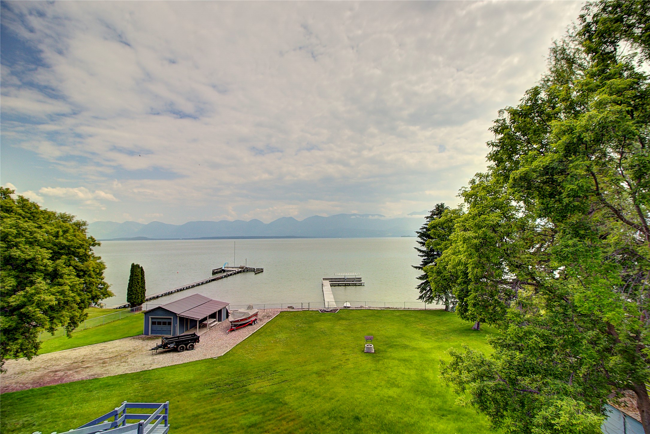 Looking for a special lake-front home with outstanding mountain views? This is it! 174' of Flathead Lake frontage, 1.70 acres, 3400 sq ft of home, 3 bedrooms, 3 baths, boat house, dock with covered boat lift, this home has it all! With a level, fenced back yard you will be having volley ball games and lots of company! The majority of the furniture is included in the purchase price. Located 1 mile east on Rocky Point Road, you are within 10 minutes of downtown Polson or 45 minutes to Kalispell. 2 water rights included, one to the well and one to the lake. Please call Susan Raub-Fortner at (406)370-2076 or your real estate professional for a private showing.