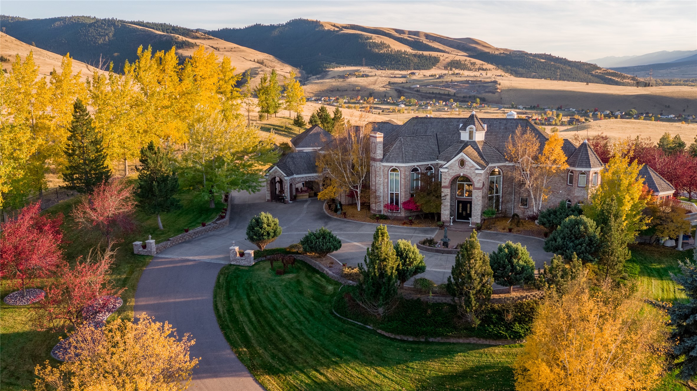 Best views you will see of Missoula and Bitterroot valleys.  County lot and borders city limits. No HOA or COV/RES on 10.73 acres. 12,000 sq ft brick estate on exquisite grounds. Roman pool and pool house, waterfall, exterior 1600 sq ft brick/motorhome building. Exterior 1200 sq ft brick detached 2 car garage. three-car attached garage. New roof May 2022. House is finished by published artists.   5 full 3 3/4 2 1/2 bathrooms 8 bedrooms; main floor master for dual careers: 2 bathrooms, 2 office rooms, 2 walk-in closets, sitting room, bar, and w/d. Custom marble, hardwood, tile floors, counters, and draperies. Walkout daylight basement, theater room, 4 laundry rooms, soaring 30 ft glass art ceiling in the entryway. Custom wooden doors, brass hardware, and baseboards. Imported marble fireplaces, and permanent lighting throughout.  Please see house description for more details. This property is truly one of a kind!