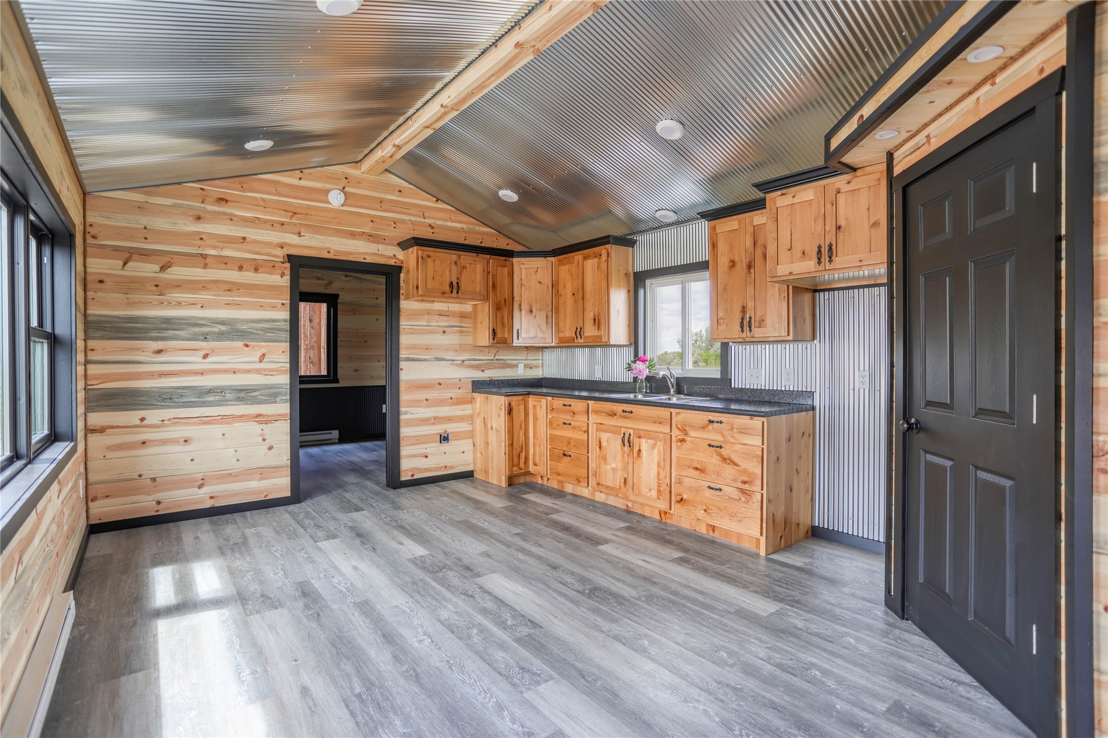 Brand NEW, 2023 custom cabin built with rough hewn Douglas Fir siding cut locally at Big Sky Sawmill.  Beautiful craftsmanship is evident in the hand fired finish.  Inside features blue pine tongue and groove from floor to vaulted ceiling, corrugated metal details, and kitchen cabinetry made by Intermountain Custom Kitchens.  Make this your private mountain retreat, perfect hunting cabin, hired-hand lodging, detached mother in law suite, or simple Airbnb!  Cabin only.  Must be moved from site.  Listed by Jen Barnett.