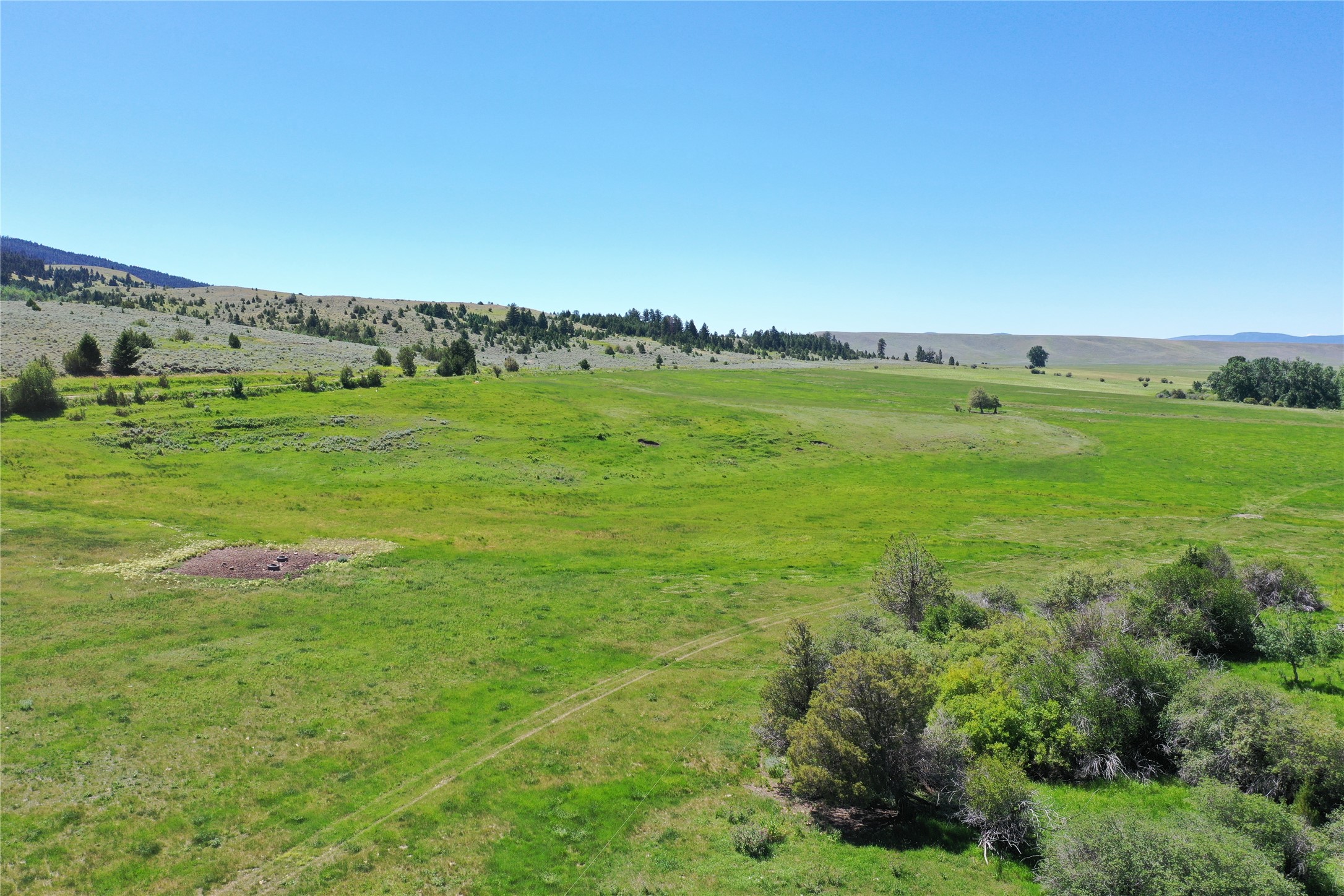 Beautiful 157.51 +/- Acre parcel with a irrigation canal running the length of the property.  Irrigation rights, irrigated meadows ... Water and Beautiful views.  You don't want to pass up this tract of land!