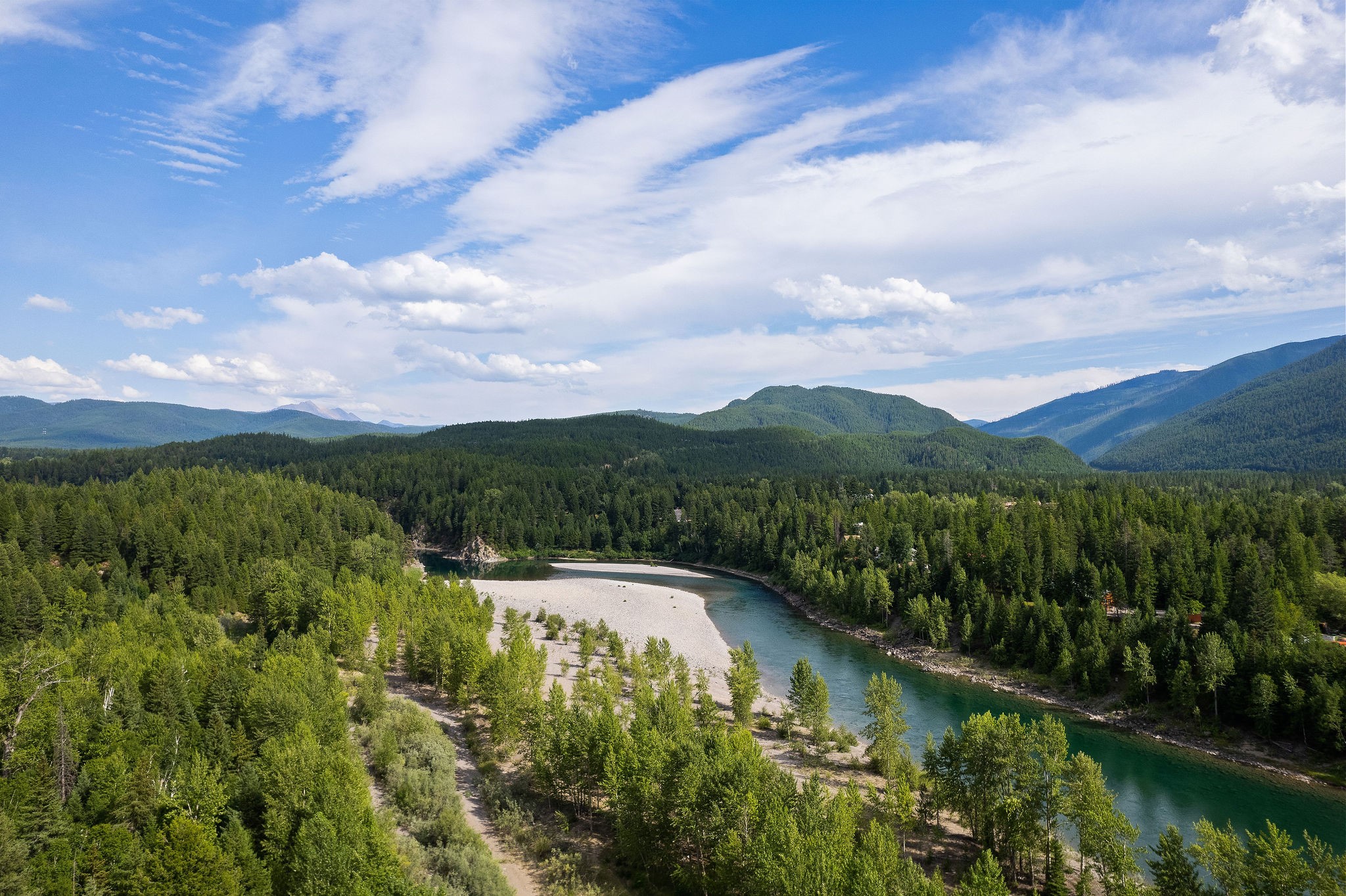 Once-in-a-lifetime opportunity to own 26.88 acres of pristine landscape with just under 820' of Flathead River frontage! Glacier National Park is minutes away! Soak in absolutely spectacular vistas of the surrounding mountain landscapes - the perfect backdrop for a Montana getaway. A beautiful building bench awaits your wildest creative endeavors. This parcel not only boasts privacy and seclusion in nature's finest, but also presents a multitude of amenities in the gated community, including a shooting range, community campfire, helipad, grill/picnic area, trails for hiking/riding, and Flathead River access for world-class fly fishing and rafting! This property is in a prime location to enjoy year-round recreational adventures, from snowmobiling, to hiking, camping, and more! Call Jennifer Shelley at 406.249.8929, Nathan May at 406.300.2689 or your real estate professional.