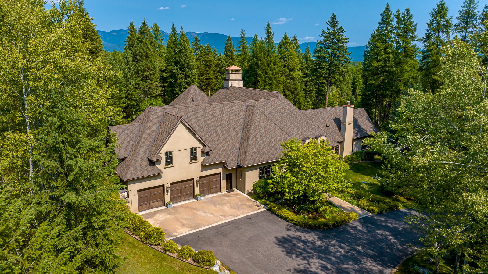 Whitefish Hills Elegance! European charm encounters Montana rustic sure to please even the most discerning of buyers. Tucked away on nearly 10 private acres in the coveted and gated Whitefish Hills community, off a winding drive lined with mature trees awaits this sprawling 6,839 sf, 4-bedroom, 5-bathroom estate exuding French Country charm. Grand features mingle with cozy warmth and the oversized windows showcase stunning views of Whitefish Mountain and bathe the home in sunlight during the day. Soaring ceilings with butternut beams, red oak flooring, and alder doors throughout lend to the properties warm & inviting atmosphere. Designed with entertaining in mind, this spectacular home features a welcoming family room, designer kitchen, complete with butler’s pantry & apron-front farmhouse sink, an outside sitting area made for sunset enjoyment, lush landscaping and so much more! Call Ken Stein 406-250-0599, Matt Buckmaster 406-261-8350, or your real estate professional for more info. Whitefish Hills amenities include hiking and horseback riding trials, and Blanchard Lake access for fishing, canoeing and paddle boarding all within a short drive from downtown Whitefish, Whitefish Lake and Whitefish Mountain Resort. Items to be noted: new pump on hot water tank, A/C has been serviced, new dishwasher and microwave, landscaping has been redone on hedges, new septic pump, driveway has been sealed, new control panel and cice maker in kitchen, bar refrigerator newer with ice, warming oven below double Viking ovens.