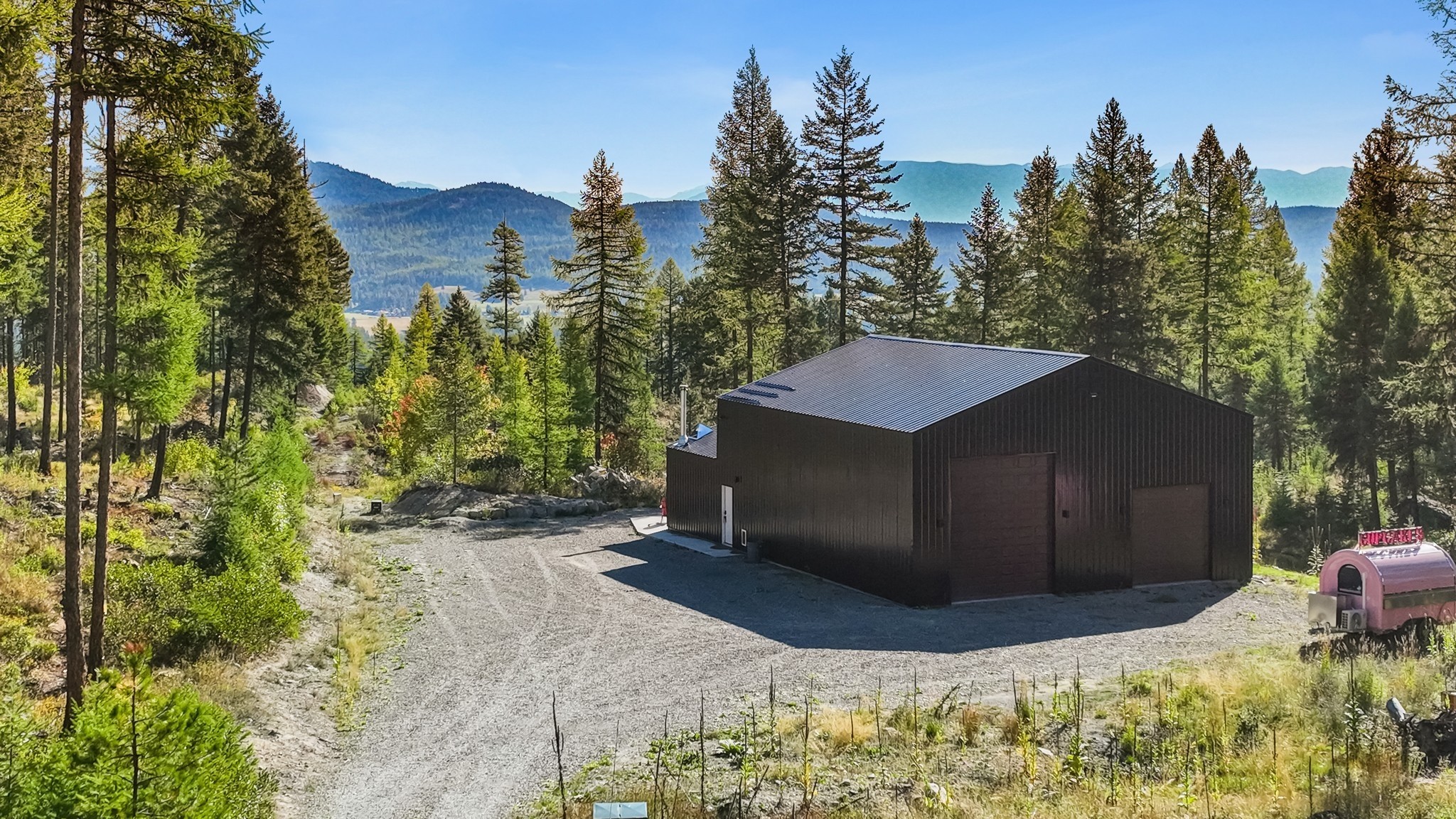 This nearly new barndominium on a very private 10 acres offers views of the Whitefish Mountain Range in a peaceful ridge top setting.   The living quarters has 2 bedrooms (or 1 bedroom +office), a 3/4 bath with an open living area and a laundry/mechanical area.    Eastern facing glass doors open to a patio for enjoying colorful sunrises over the mountains and wildlife galore.  The comfortable apartment is attached to the large foam insulated heated garage/shop (1547 Sq. Ft.) which has room to store all your outdoor toys and equipment.  Septic permit of record is for 5 bedrooms. RV hook-up and electric and septic clean out. Live in the apartment while building your Montana dream home.  Northern boundary borders the National Forest Service for unlimited exploration and privacy.  Call Hunter Homes at 406-314-1417 or your real estate professional for a private tour.