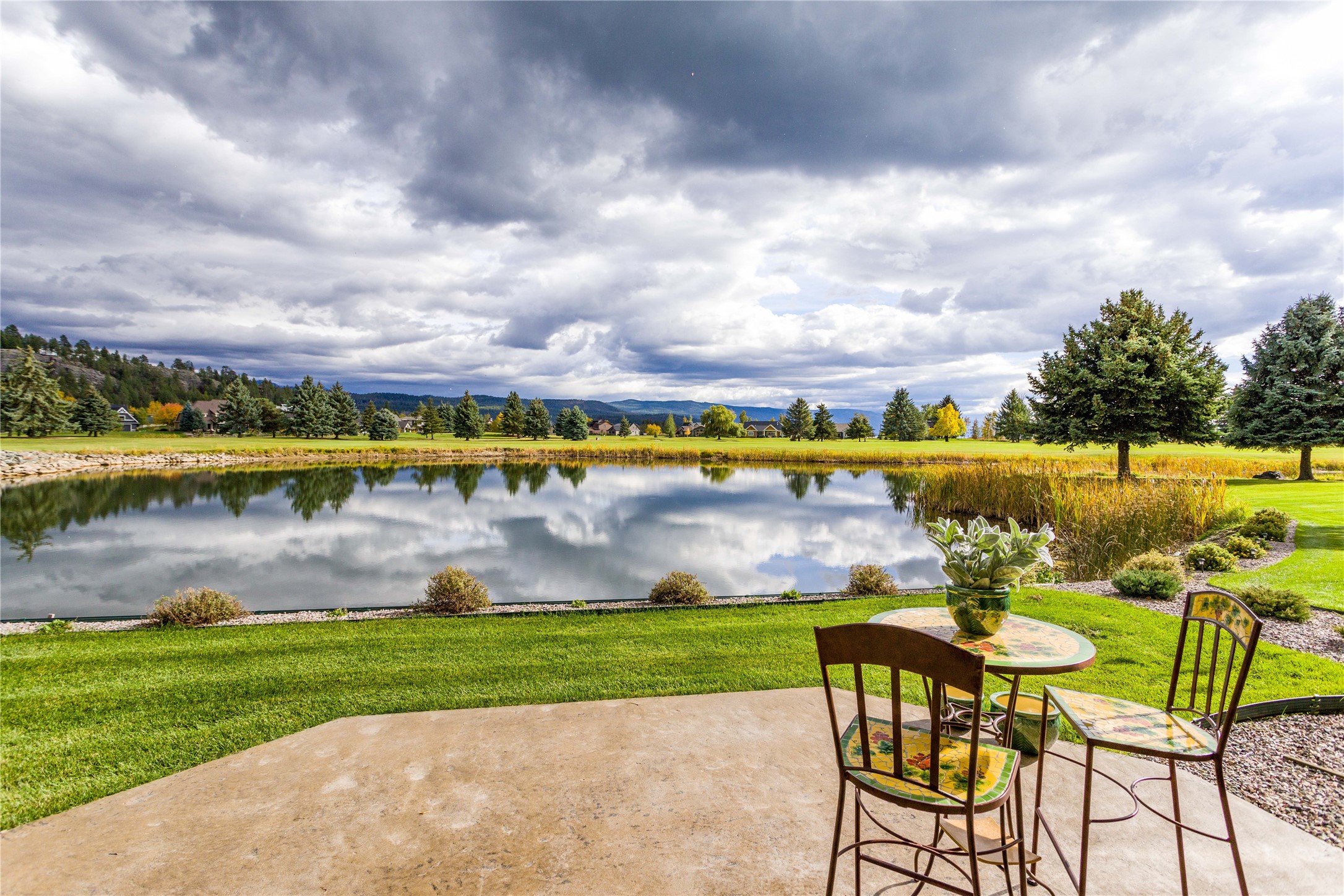 A wonderful two-story townhome overlooking the pond & the 8th fairway on the Osprey 9 at the Eagle Bend golf course. The patio & guest room balcony capture the views of the Mission Mountains to the southeast & Flathead Lake to the south. The spacious kitchen connects to the dining room, which opens to the comfortable living room with a cozy corner fireplace & expansive sliding doors to the patio bordering the pond. The main floor consists of the primary suite with soaking tub, separate shower & walk-in closet; the laundry room is connected to the over-sized double garage & convenient to the adjoining powder room. The upper level features two guest suites, one with a viewing balcony & the other with a huge storage closet, separated by the loft office. The residence is located only minutes from the Eagle Bend clubhouse, the Eagle Bend Yacht Harbor, the Montana Athletic Club & the quaint village of Bigfork. Glacier International Airport & Glacier National Park are within an hour away.