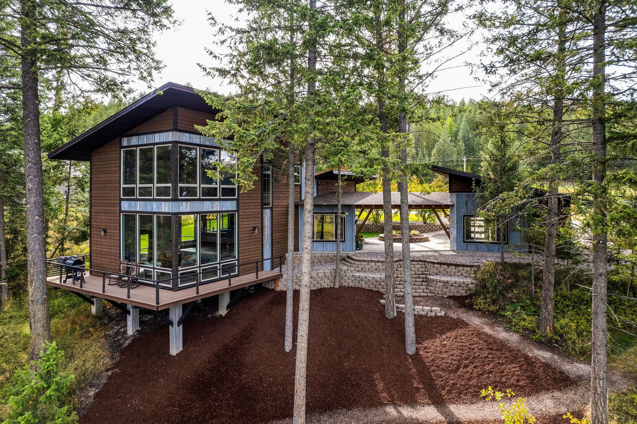 Just Minutes from downtown Bigfork sits this stunning mountain modern home. Built in 2017, this high-end 3 bedroom, 3 bathroom house  features an oversized detached garage with a covered breezeway.   As you step inside, an abundance of natural light filters through floor-to-ceiling windows with breathtaking Swan Mountain views.   An open floor plan welcomes you into the gourmet kitchen with large walk-in pantry.  The master bedroom view will leave you speechless, complete with in-suite bath and walk-in closet.  The comfortable living area walks out to a wrap around deck with a Montana dream back yard.   A walkway to your private dock and shared pond is an outdoorsman and bird watchers' paradise.  Hand laid herringbone tile flooring and many other custom features. 
Contact Tim Killen at 406-897-4289, or your real estate professional.