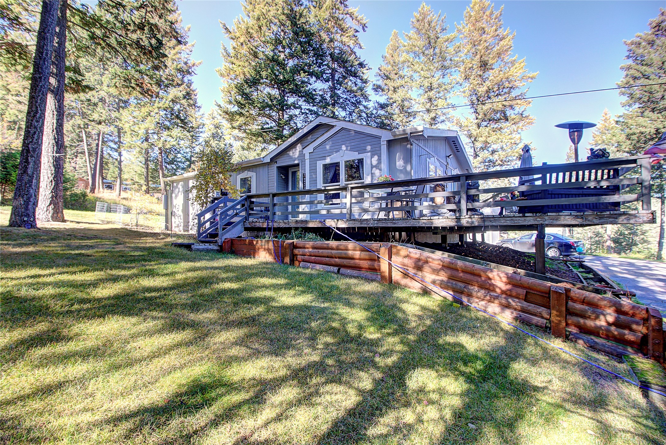 Great location in the heart of Lakeside with views of Flathead Lake very private with nice matures trees. Remodeled in about 2019. Is a 3 bedroom, 2 bath manufactured home on a permanent foundation. ( 3 bedroom does not have closet) Granite bathroom countertops, concrete kitchen countertops, double pane windows throughout, large deck on three sides. Detached 2 car garage plus nice storage shed all on 0.57. Only minute's to Flathead Lake and BlackTail ski Resort. MOTIVATED SELLER,will include Four-Wheeler and snowplow in the sale. Call Cindy Lanier at 406 250-5273 or your real estate professional.