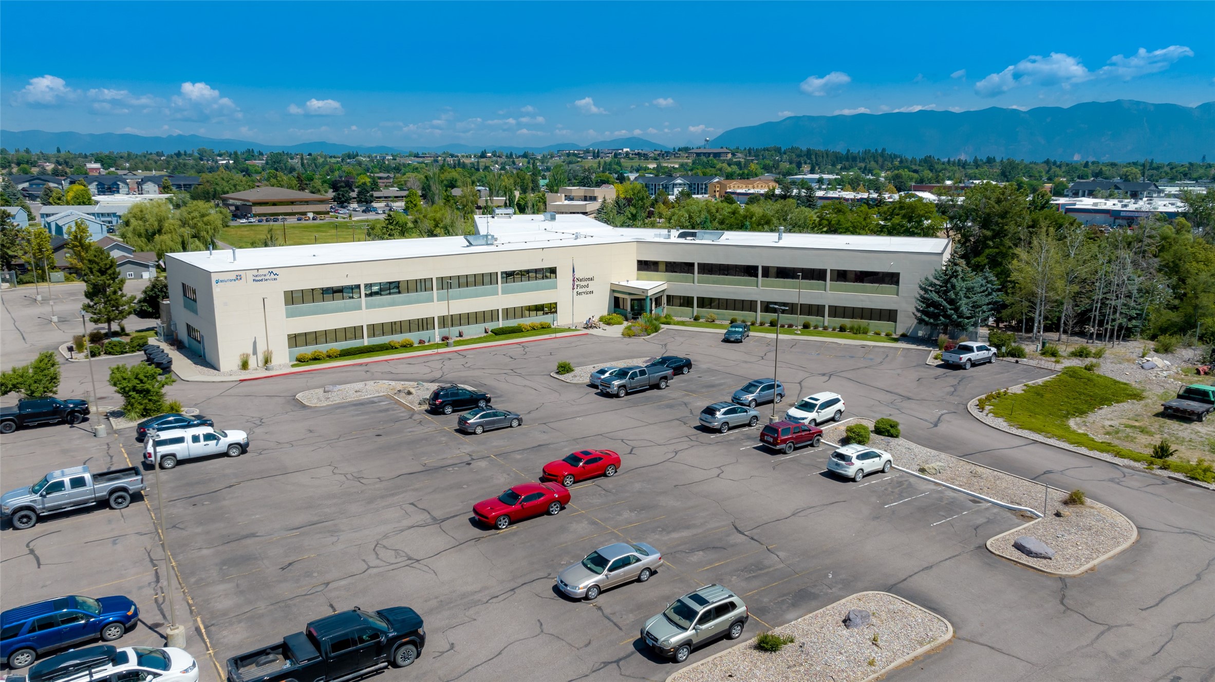 If you’re in the market for high-grade professional office space — of any size — check out the opportunities at this highly functional, secure and flexible office building just west of the Kalispell city center. Conveniently located close to US Highway 2 and the US Highway 93 bypass, this building offers easy access, abundant parking, screaming-fast fiber optic data lines, a shared common area/lunch room, and the opportunities for multiple office configurations. Furnishings include dividers, desks, chairs, conference room tables, etc… all at no additional cost. You need to see this facility to believe it. Whether you need a couple 200sf offices or the entire 22,000+ space — or anything in between — we have a home for you. Space available at $11/sf/year base lease + $3/sf/year CAMs.  Call David Stone at 406-250-7249, or your real estate professional.