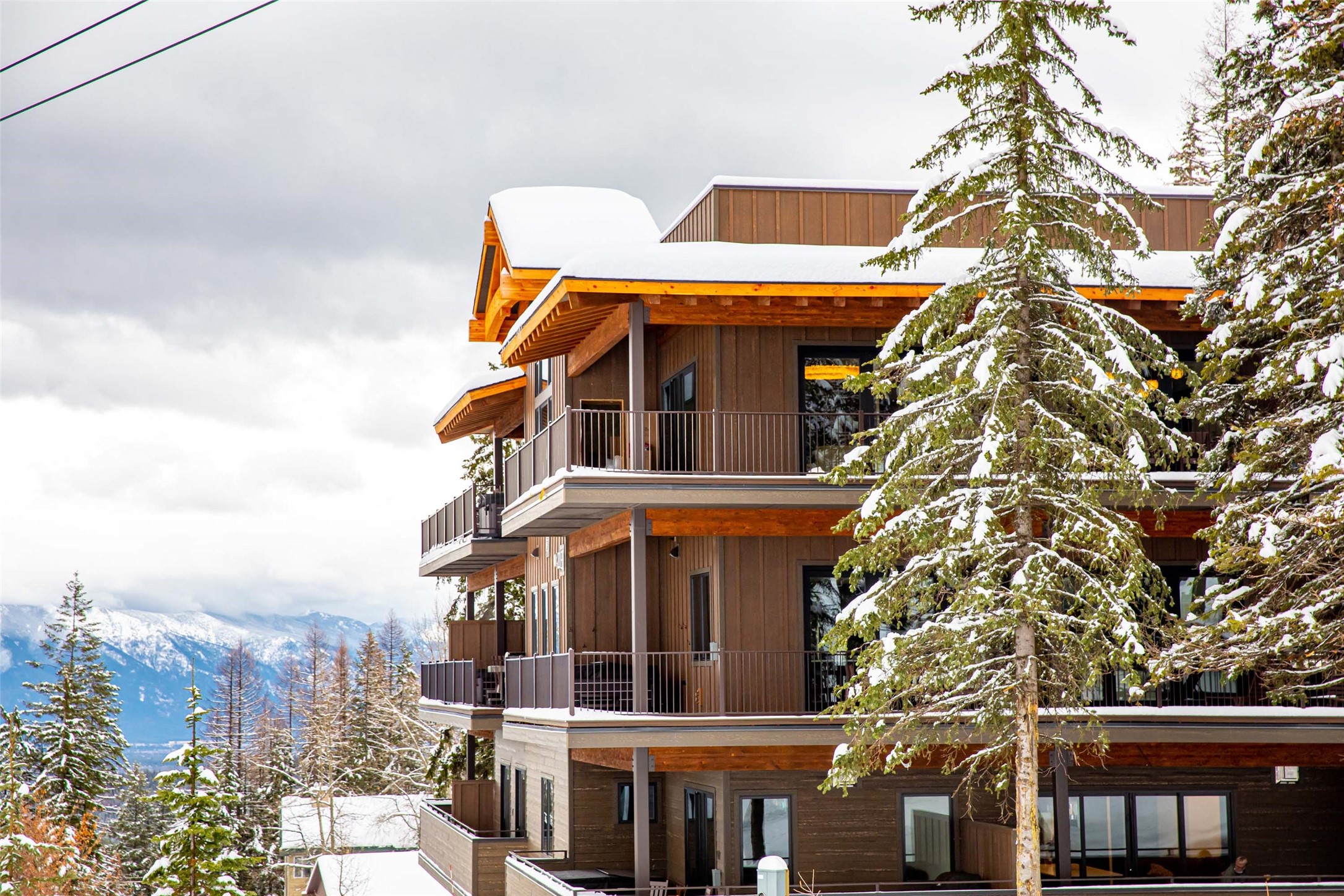 Ski-in, ski-out of this fabulous slope side condo at Whitefish Mountain Resort! Built in 2020 and immaculately maintained, this fully furnished condo is ready for your immediate enjoyment or to rent out short-term as an investment asset. 3 bedrooms with ensuite baths and a powder room offer plenty of space for guests. An open floor plan utilizes the large space beautifully and opens onto a wraparound deck with a hot tub to relax after a day of skiing. In-floor heating in the bathrooms, central AC and heat throughout, wonderfully appointed furnishings and high-end appliances are a few of the perks inside the condo. Lovely views from the large windows overlooking the ski hill and direct access to the slopes will have you enjoying your vacation in style. A fitness center, ski locker room, and heated garage with owner's storage area are a few of the amenities available to you. Please call Matt Zignego at 406-212-2792 or your real estate professional for more info or to schedule a showing.