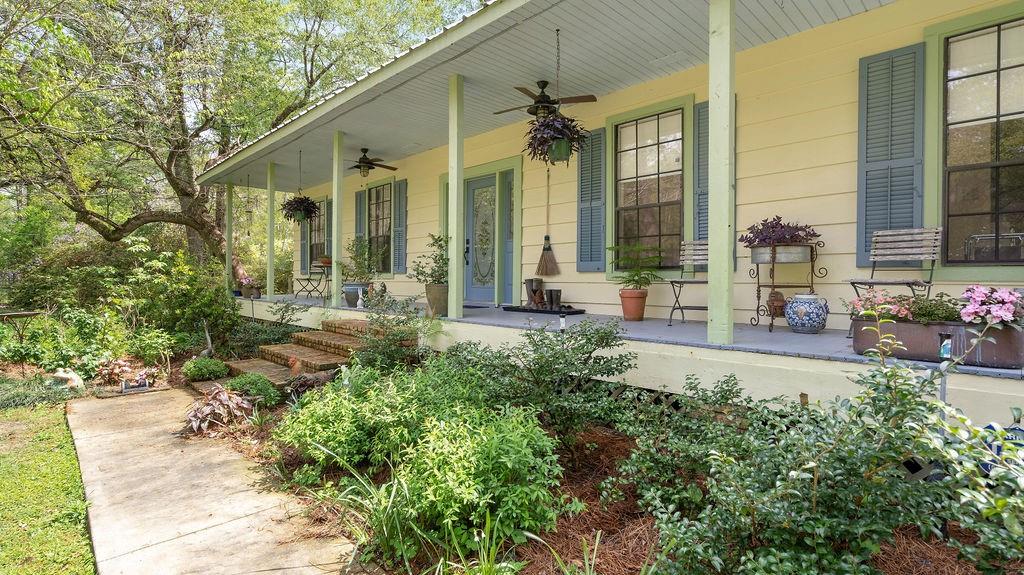 Beautiful renovated 4/3 farmhouse w/livestock barn, 1500sf workshop & art studio on 13 acres in Abita Springs; home of Abita Brewery, Abita Opry, Tammany Trace & Sunday Farmer's Market. Fenced & cross-fenced, whole house generator, 2 new geothermal units, pellet stove, heart of pine floors. 2 stocked ponds, chicken coop, bee hive, large blueberry patch, greenhouse & raised vegetable beds.  Large front porch, screened back porch, & pergola w/fire pit. Primary w/2 walk-in closets. Laundry w/2 large pantries.