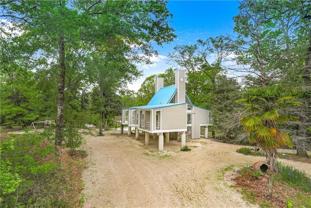 Architectural Beauty-Riverfront on high bluff overlooks private sugar sand beach on 5 park-like acres. (Adjacent 5ac lot available(Lot #10-$150K)$599k. BR balconies + 1 large deck overlooks beach. Viking stove & DW, electric waiter to main level, 3 covered parking bays. 
M/suite w/vault ceiling, jet soaker tub, steam shower, marble vessel sink, oak flooring w/ceramic in kitchen/din rm. Efficient geothermal a/c system, excellent well water, gas appls, truly a sanctuary an hour from N.O. & B.R.