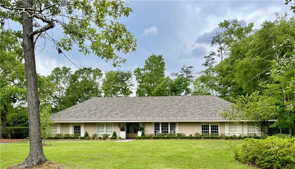 Wonderfully renovated ranch, perfect to fill w/ family memories.  This house features modern technology to make your life easy, including blue tooth remotely controlled appliance in a fabulous kitchen.  The kitchen bar, mantle & hood are crafted of sinker cypress from Lake Maurepas.  It sits pretty on just shy of an acre corner lot with lots of trees.  Cathedral ceilings in the kitchen, den, sunroom & master bedroom add to its beauty.  It is hard wired for sound & internet.  This house lives easy and quiet.