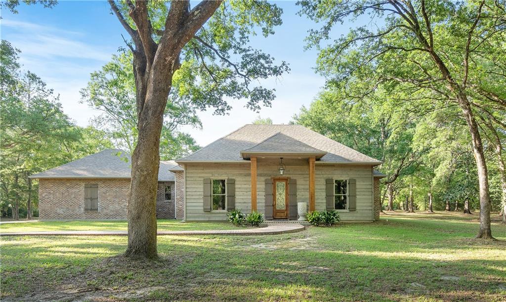 A true retreat with 50 Live Oak trees! 5+ acres on 1 of the highest ridges in St. Tammany at 102 ft above sea level. Just 10 minutes from Abita Springs, Abita Brew Pub and the Tammany Trace.  This home has been built with the highest quality in mind;  low maintenance with brick & cedar.  Interior walls insulated for additional quiet. High ceilings with a beautiful view from every room.  Great back porch to entertain on or just hangout in a hammock swing chair.  Plenty of room to make your dreams come true.