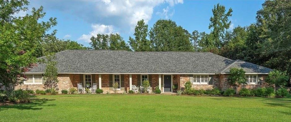 WOW! Classic beautiful ranch of old New Orleans brick on almost an acre lot. 10' ceilings in all living areas and primary suite. Chef's kitchen with slab granite counters & island, and stainless steel top of the line appliances with new ice maker, dishwasher and ovens. Large living space and wonderful sunroom overlooking newly resurfaced 16x32 pool and cabana with 1/2 bath and kitchenette.  New primary suite added in 2015. New antique heart of pine floors in dining room, new roof and hot water heater 2021.