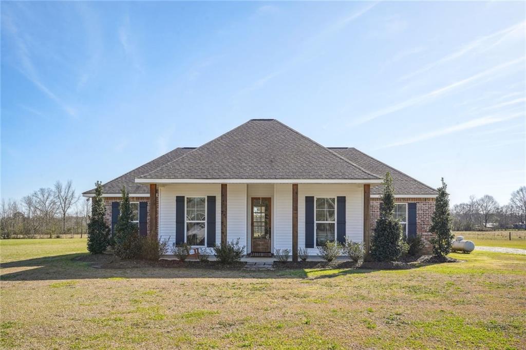 Picturesque 4bd/2bth Farmhouse sits on 4.7 acres w/360-degree expansive, peaceful green views. Long, extended driveway w/ample parking. Large covered front & back porch. Open floor plan, great for entertaining, w/an abundance of natural light, centered around a wood-burning fireplace. Kitchen boasts large center island w/storage, granite counters, SS Energy Star appliances & breakfast area. Crown molding, recessed lighting & luxury vinyl wood flooring throughout; NO Carpet. Beautifully unique, a MUST SEE!