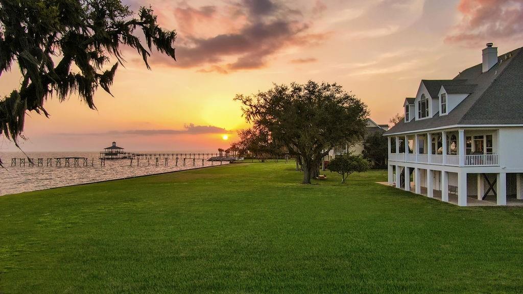 Dream Lewisburg home on Lake Pontchartrain with amazing sunsets. Soaring windows across the back overlooking an expansive lawn with swaying moss in the huge oaks and the lake that never ceases to fascinate. High ceilings with wood floors and beautifully remodeled kitchen w/ Calacatta Vagli Marble & Wolf/Subzero appliances. Primary bedroom with gorgeous views of the lake and newly renovated Marble Primary Bath with exceptional walk in shower and his and her closets. Private boat launch.