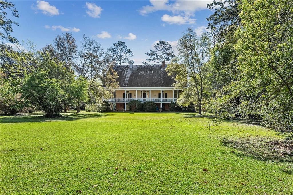 This is the opportunity to own a remarkable piece of history! A stunning 1855 center-hall Creole Cottage awaits, perfectly situated on a generous 4.92 acres on the picturesque banks of the Bogue Falaya river in downtown Covington. Boasting a grand wrap around front balcony, 2 beautifully designed screened-in porches, and a stunning slate roof, this fantastic property has been well maintained throughout the years. Watch the world go by from the unique and ornate glass conservatory that promises to provide endless hours of relaxation and entertainment. With more than enough land to spread out, this dreamy oasis is truly one of a kind. Don’t wait to make this remarkable treasure your own!