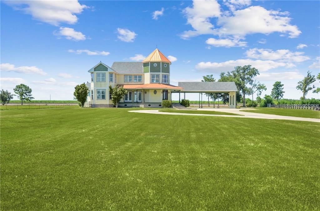 Unparalleled opportunity to own a 2.59-Acre private retreat along the tranquil Mississippi River. This Victorian style estate is framed by rolling Louisiana sugar cane fields and awaiting your personal touch. The 4,710 SF+/- residence, built in 2009, encompasses 5 bedroom, 4.5 bath is the embodiment of timeless southern elegance!  Enjoy this spacious home in all seasons with its open floor plan and breathtaking views and sunlight from every room. Coffered ceilings, custom oak doors, brazilian oak floors, a crystal chandelier, are among the elegant touches that grace this space. The kitchen seamlessly connects with the living area with French Doors leading to the wrap-around porch for indoor/outdoor living. Large Primary with spa-like bath, walk-through rainfall shower with steam setting, dual vanities and spacious walk-in closet.The expansive outdoor space is enhanced by meticulously manicured grounds surrounded by lush greenery with ample space for a pool or outdoor oasis limited only by your imagination. Wired for both surround sound and a security system. New Roof in 2022. The canvas of your dreams! *Virtual Renderings included for reference