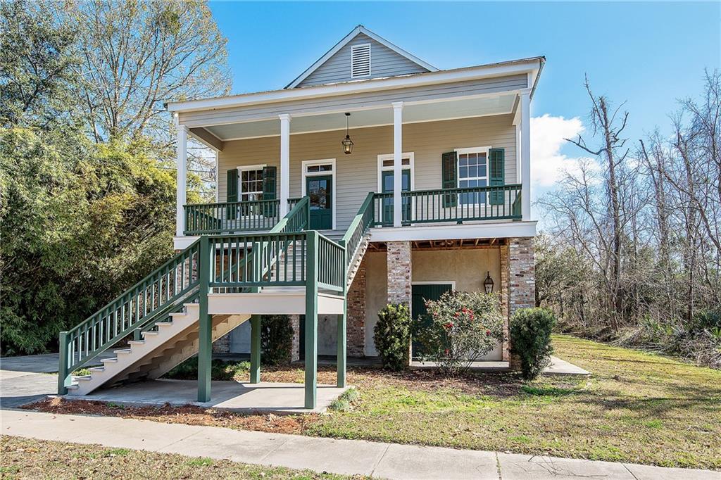 Authentic Old New Orleans charm permeates this turn of the century and recently raised Madisonville cottage in beautiful condition. Wood floors, high ceilings, spacious bedrooms, & and deep front & back porches. The double carport functions as a shop area with sink, in addition to RV hookups & covered boat area. Ground level completely finished with soaring ceilings & plenty of room for crawfish boils & entertaining. Walk to restaurants, shops & all that Madisonville has to offer!